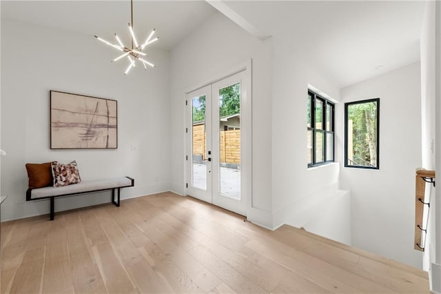 6178 Lake Lanier Height Rd, Buford, GA 30518 - entryway featuring french doors, a chandelier, light wood-style floors, and vaulted ceiling