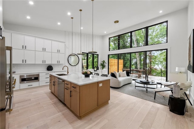 6178 Lake Lanier Height Rd, Buford, GA 30518 - kitchen with a high ceiling, dishwasher, light wood-style floors, recessed lighting, and plenty of natural light