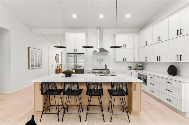 6178 Lake Lanier Height Rd, Buford, GA 30518 - kitchen featuring high quality fridge, wall chimney exhaust hood, decorative backsplash, light wood-style floors, and recessed lighting