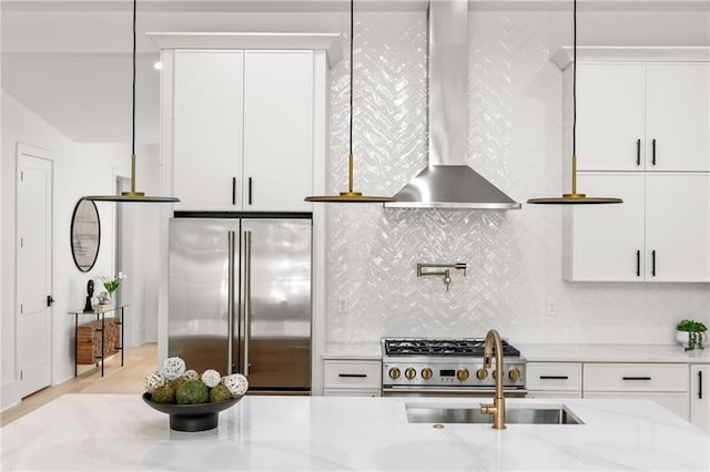 6178 Lake Lanier Height Rd, Buford, GA 30518 - kitchen featuring high end appliances, wall chimney range hood, tasteful backsplash, light stone countertops, and white cabinets
