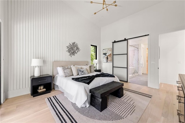 6178 Lake Lanier Height Rd, Buford, GA 30518 - bedroom with a towering ceiling, a chandelier, and light wood finished floors
