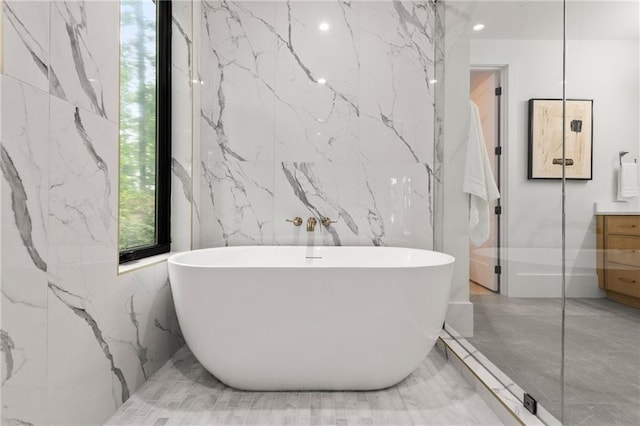 6178 Lake Lanier Height Rd, Buford, GA 30518 - bathroom with marble tiled floors, stone wall, vanity, and recessed lighting