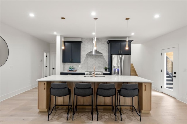 6178 Lake Lanier Height Rd, Buford, GA 30518 - kitchen featuring stainless steel refrigerator with ice dispenser, wall chimney exhaust hood, a spacious island, tasteful backsplash, and light wood-style floors