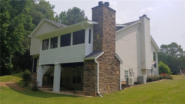 back of house with a yard, a patio, and central air condition unit