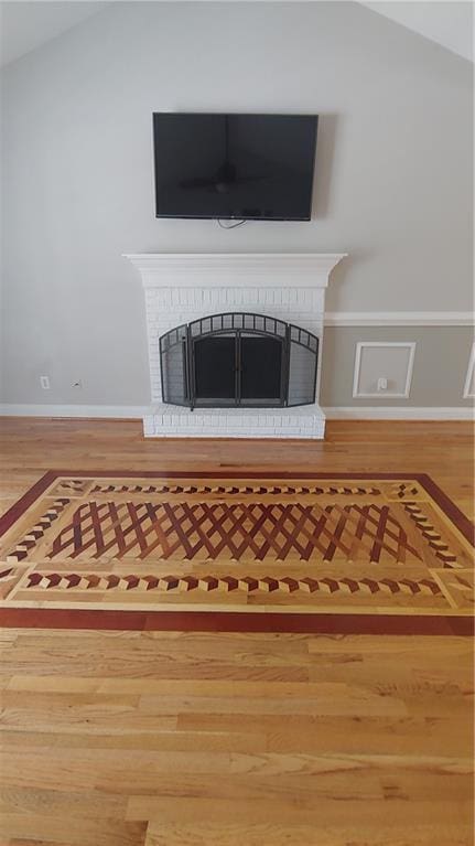 interior details featuring a fireplace and hardwood / wood-style flooring