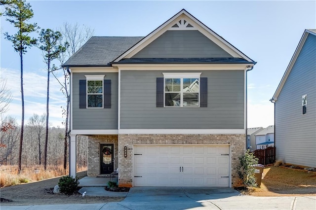 craftsman house featuring concrete driveway, an attached garage, and brick siding