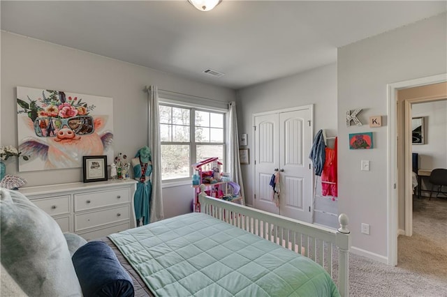 bedroom featuring light carpet, a closet, and baseboards
