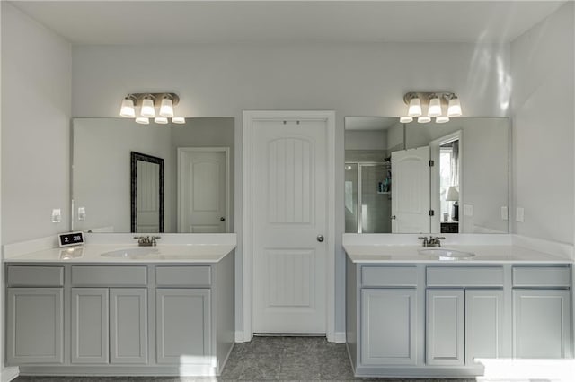 bathroom with a stall shower, two vanities, and tile patterned floors