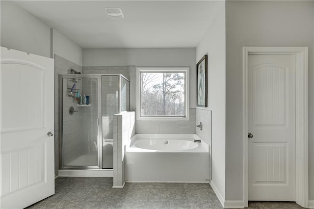 full bathroom featuring a stall shower and a garden tub
