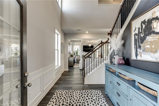 entrance foyer featuring stairs, dark wood-type flooring, and ceiling fan