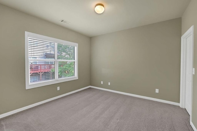 unfurnished room with light colored carpet