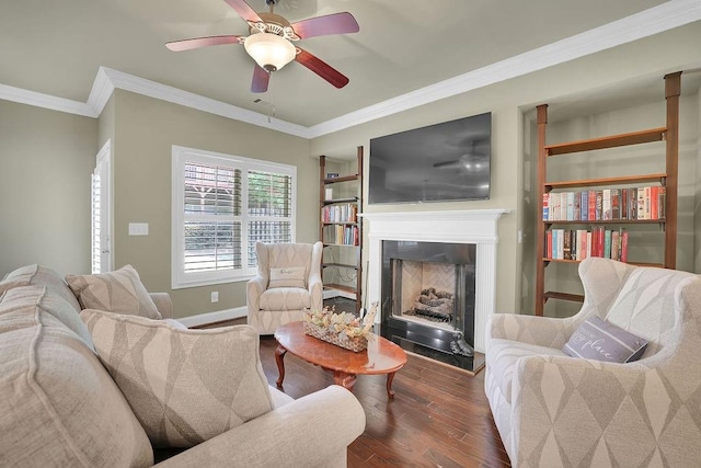 living room with crown molding, dark hardwood / wood-style floors, and ceiling fan