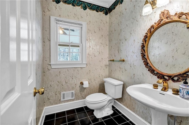 bathroom with tile patterned flooring, visible vents, baseboards, toilet, and a sink