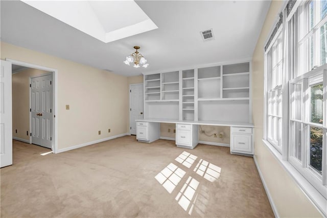 unfurnished office featuring light carpet, a notable chandelier, built in study area, and baseboards