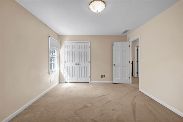 unfurnished bedroom with a closet, carpet flooring, and baseboards