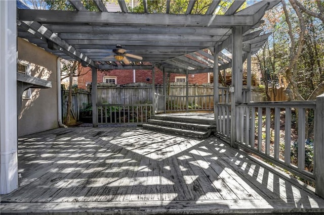 wooden deck with fence, a ceiling fan, and a pergola