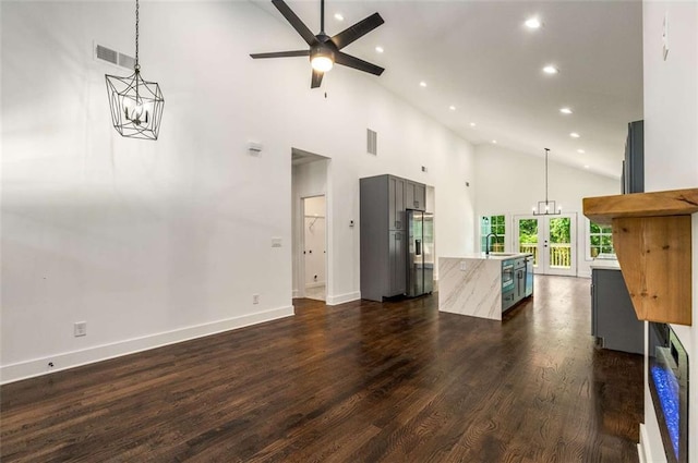 1317 Bernard St NW, Atlanta, GA 30314 - unfurnished living room featuring high vaulted ceiling, recessed lighting, a ceiling fan, a chandelier, and baseboards
