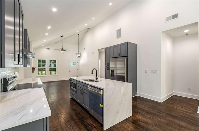 1317 Bernard St NW, Atlanta, GA 30314 - kitchen with appliances with stainless steel finishes, a sink, a ceiling fan, dark wood finished floors, and light stone countertops
