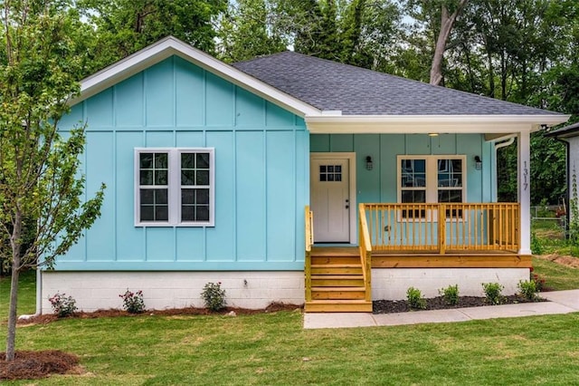 1317 Bernard St NW, Atlanta, GA 30314 - view of front of property with board and batten siding, roof with shingles, a porch, and a front yard