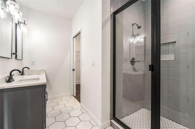 1317 Bernard St NW, Atlanta, GA 30314 - bathroom featuring a shower stall, tile patterned floors, a walk in closet, double vanity, and baseboards