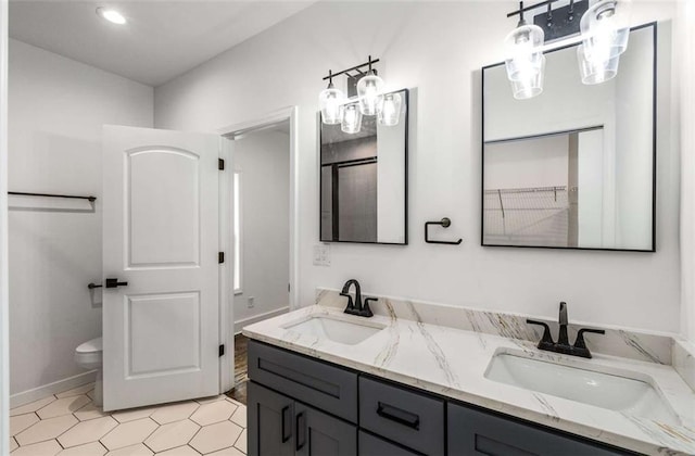1317 Bernard St NW, Atlanta, GA 30314 - full bath with double vanity, toilet, recessed lighting, baseboards, and tile patterned flooring