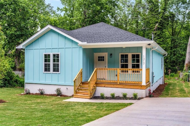 1317 Bernard St NW, Atlanta, GA 30314 - bungalow-style house featuring a porch, roof with shingles, board and batten siding, and a front yard
