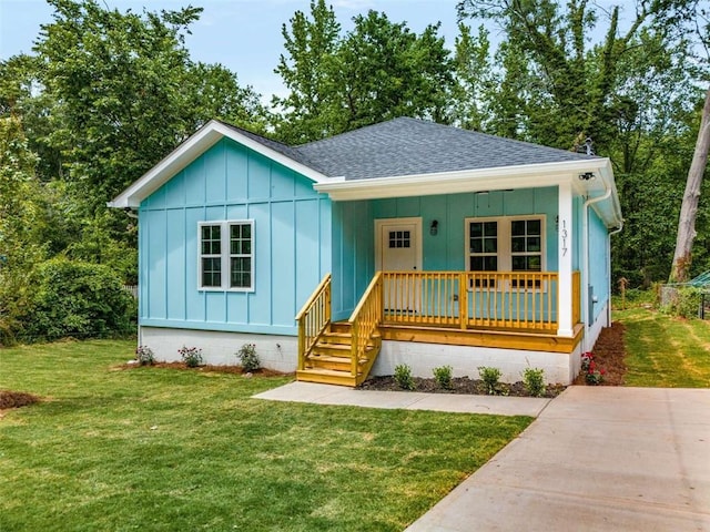 1317 Bernard St NW, Atlanta, GA 30314 - bungalow-style house featuring a shingled roof, covered porch, board and batten siding, and a front yard