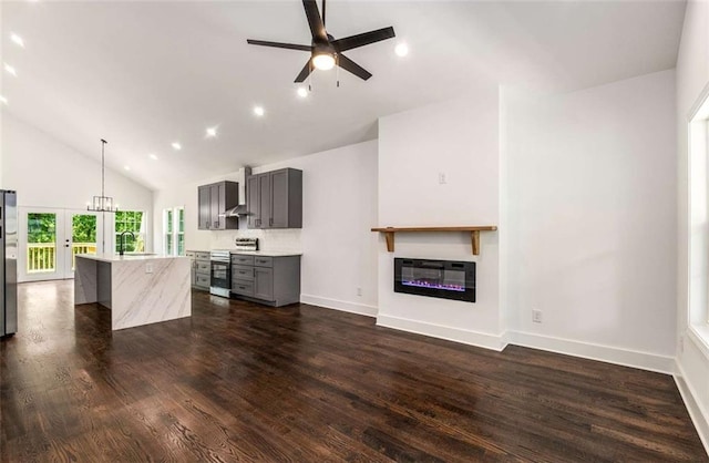 1317 Bernard St NW, Atlanta, GA 30314 - unfurnished living room featuring a glass covered fireplace, heating unit, high vaulted ceiling, ceiling fan, and baseboards