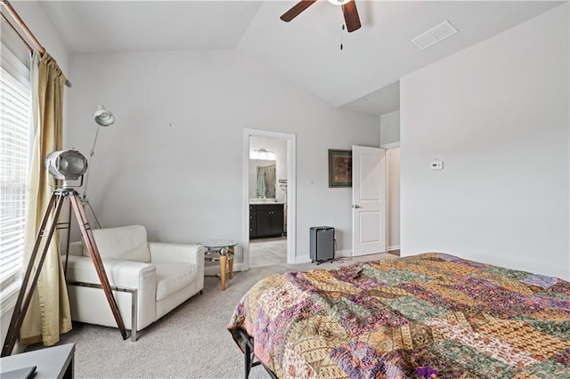 carpeted bedroom featuring lofted ceiling, ensuite bath, and ceiling fan