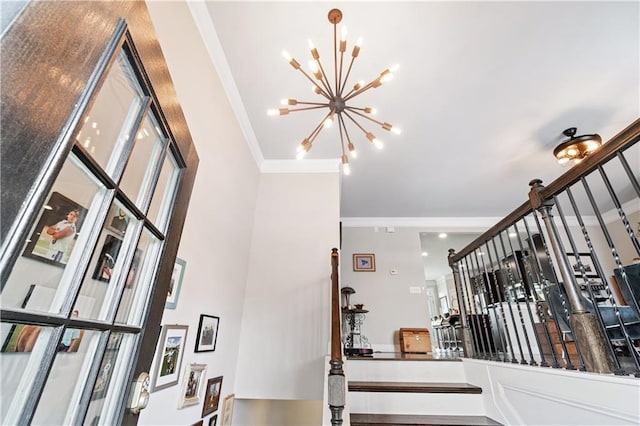 staircase with crown molding and a notable chandelier