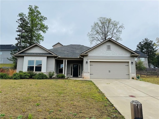 view of front of house featuring a garage, fence, a front yard, a shingled roof, and concrete driveway