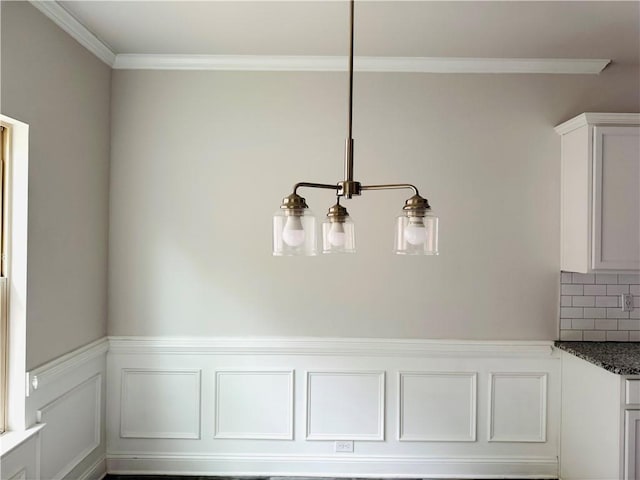 details featuring backsplash, wainscoting, and ornamental molding