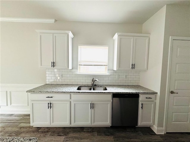 kitchen with white cabinetry, light stone counters, a sink, and dishwasher