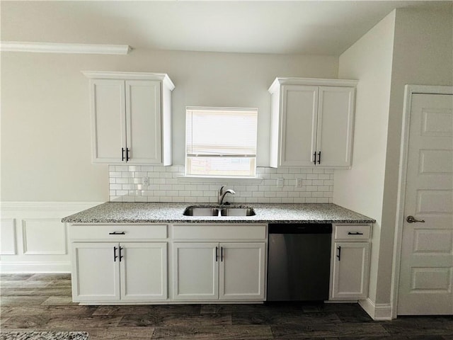 kitchen featuring white cabinets, light stone countertops, a sink, and dishwasher