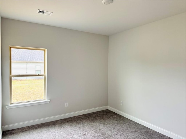 unfurnished room with carpet floors, baseboards, and visible vents