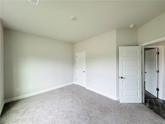 unfurnished bedroom featuring baseboards and carpet flooring