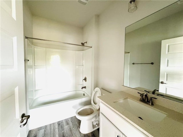bathroom featuring shower / bathtub combination, vanity, toilet, and wood finished floors