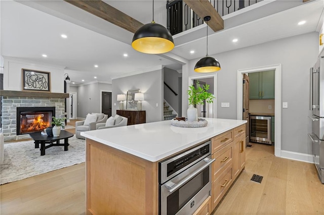 12995 Bucksport Dr, Roswell, GA 30075 - kitchen featuring wine cooler, light wood-style flooring, appliances with stainless steel finishes, a center island, and recessed lighting