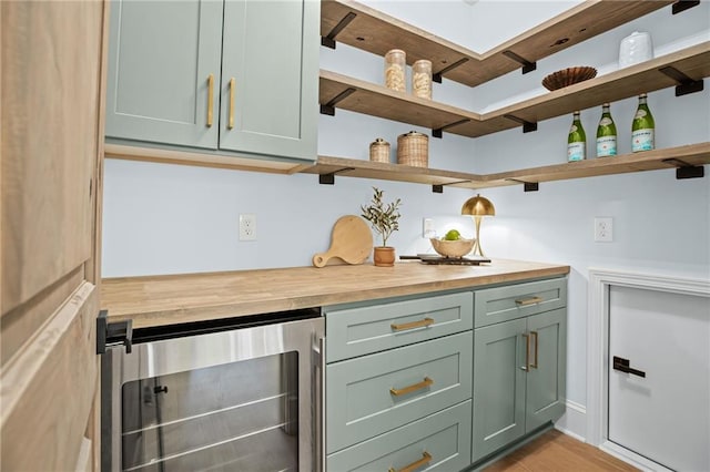 12995 Bucksport Dr, Roswell, GA 30075 - kitchen with beverage cooler, green cabinetry, butcher block counters, open shelves, and light wood-type flooring