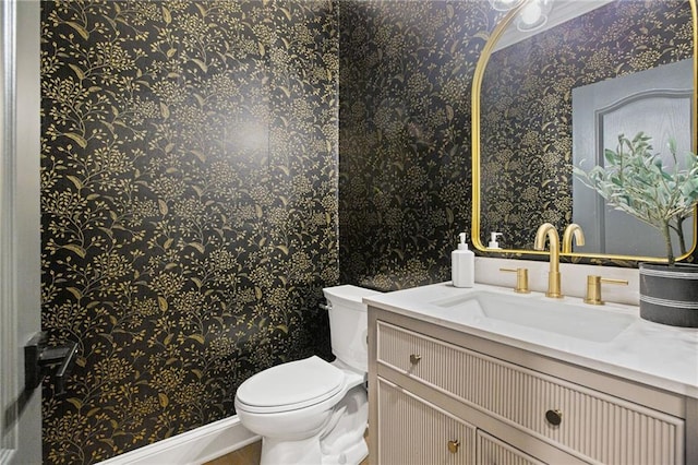 12995 Bucksport Dr, Roswell, GA 30075 - half bath featuring wallpapered walls, vanity, toilet, and wood finished floors