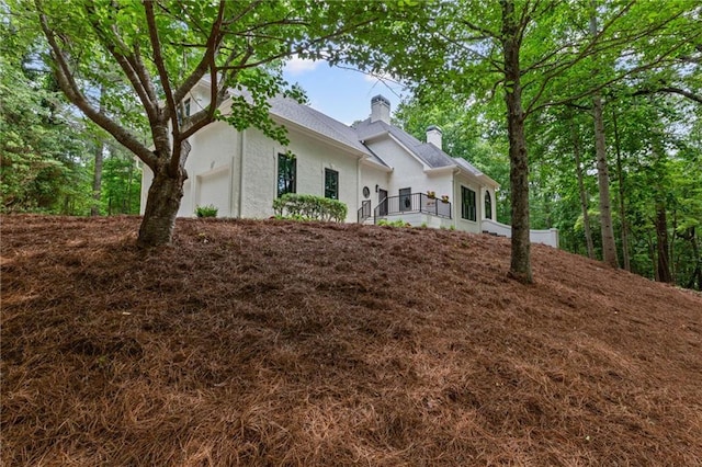 12995 Bucksport Dr, Roswell, GA 30075 - view of front of property featuring a chimney, stucco siding, and an attached garage