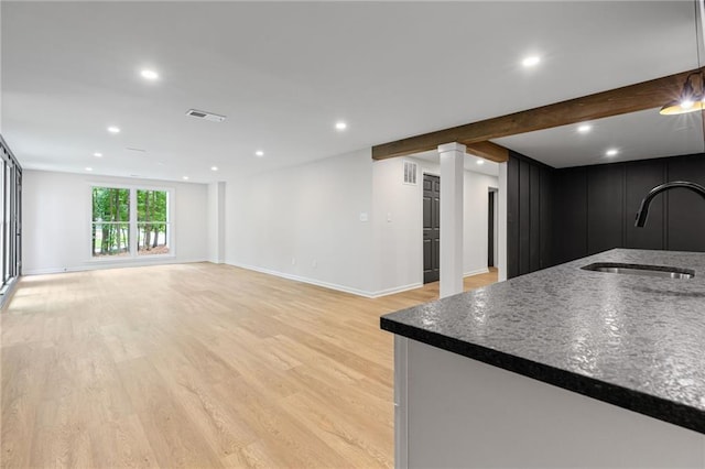 12995 Bucksport Dr, Roswell, GA 30075 - unfurnished living room with a sink, recessed lighting, light wood-style flooring, baseboards, and ornate columns