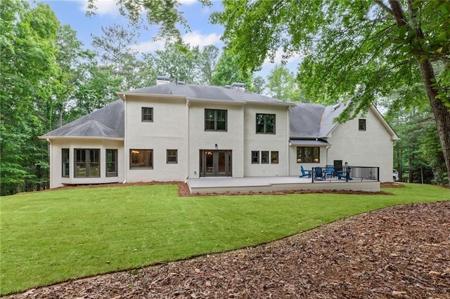 12995 Bucksport Dr, Roswell, GA 30075 - back of property with a lawn, stucco siding, a chimney, and a patio area