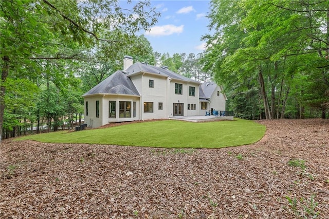 12995 Bucksport Dr, Roswell, GA 30075 - rear view of house with a chimney, stucco siding, a patio area, and a lawn
