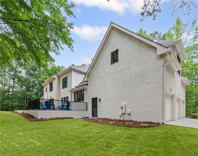 12995 Bucksport Dr, Roswell, GA 30075 - rear view of property with stucco siding, a lawn, and an attached garage