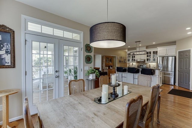 dining room featuring light hardwood / wood-style floors and french doors