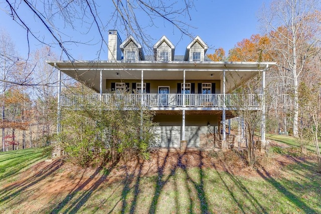 back of property with a porch and a lawn