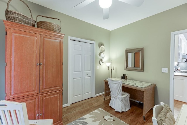 office with ceiling fan and light hardwood / wood-style floors