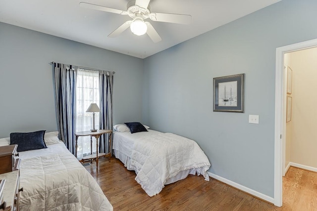 bedroom with hardwood / wood-style flooring and ceiling fan