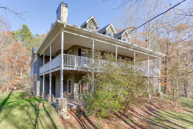 view of side of property with a balcony